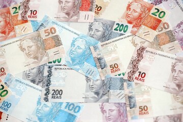 Brazilian reais banknotes. The current Brazil real money bills lies on table in big amount