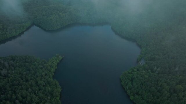 Aerial drone tops down Onneto Lake in Hokkaido Japan, national park landscape around forested area