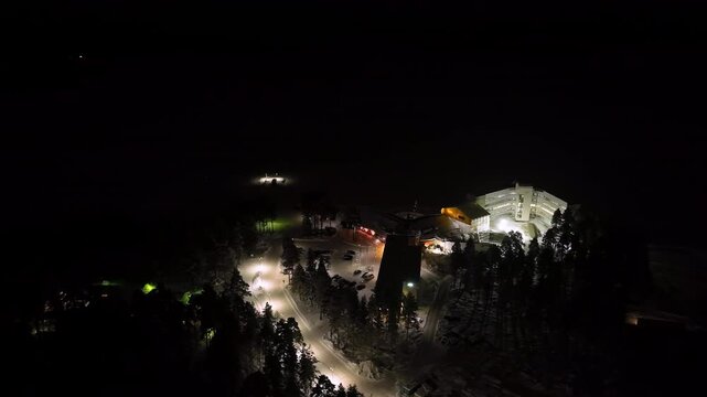 Aerial view circling the Bomba resort, cold, winter evening in Nurmes, Finland