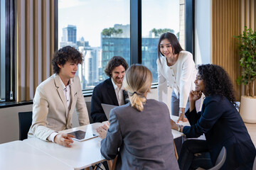 Asian woman sale manager is showing annual report to her colleague in executive meeting for next...