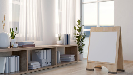 Blank signboard on wooden floor with a bookshelf and curtain covered windows aside in a bright room.