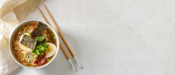 Tasty Chinese soup with chicken in bowl on light background