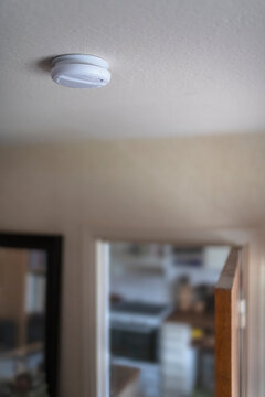 Close-up of smoke detector on ceiling of home