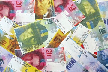 Swiss franc banknotes. The current francs money bills lies on table in big amount