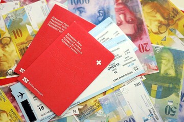 Swiss franc banknotes and passport with tickets. The current francs money bills and biometrical pass