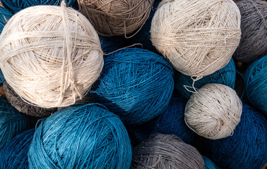 natural yarn ball in blue and white color. crochet yarn, knitting yarn cotton fiber mixed with hemp fiber, naturally dyed. colorful threads for needlework, cotton fabric texture pattern background