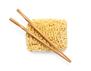 Raw instant noodles and wooden chopsticks on white background