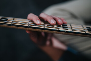 Detailed photograph of a musician's hand pressing guitar strings, emphasizing the craftsmanship of...