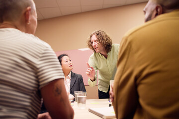 Low angle view of businessman explaining strategy to colleagues during meeting in office board room