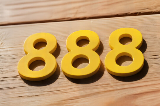 wooden numerals 888 painted in gold on a dark brown and white patterned plank background concept n&uacute;meros de madera 888 pintados en dorado sobre un fondo tablones estampados en marr&oacute;n oscuro y blanco