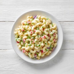 Creamy pasta salad, a vibrant mix of macaroni, peas, bell peppers, and onion, served on a white plate