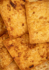 Nacho chips texture. Tortilla chips. Taco chips. Close-up. Food background. Tasty snack. Group of crispy corn chips isolated on white background.