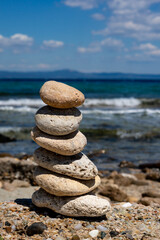 stack of balance stones on the beach, Mediterranean vertical