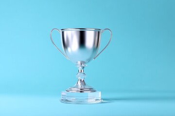 Elegant silver trophy on clear pedestal with blue background