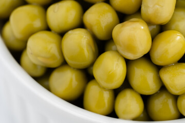 Fresh green peas background, texture of perfect peeled sweet pea grains as background. Vegetable background, vegetable protein, healthy products. Canned peas.