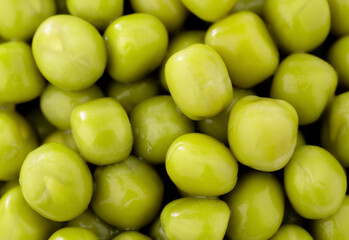 Fresh green peas background, texture of perfect peeled sweet pea grains as background. Vegetable background, vegetable protein, healthy products. Canned peas.