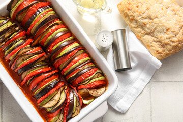 Baking dish of tasty Ratatouille on white tile background