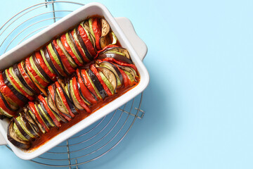 Baking dish of tasty Ratatouille on blue background