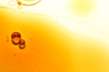 Macro View of Orange Oil Droplets on Smooth Bright Background