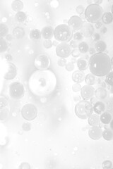 Transparent Bubbles Floating in Soft Focus on Light Background