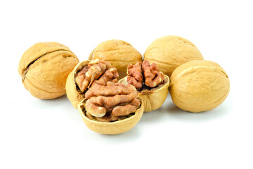 walnuts and nutcracker, Close up of roasted walnuts or Juglans regia  isolated on white background with clipping path stack, hard yellow shell and crunchy brown pulp