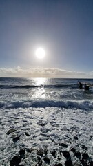 Praia das Palmeiras in Santa Cruz, Madeira, is a popular seaside spot featuring a rocky shoreline, sunbathing platforms, and easy access to the ocean. Locals and visitors come here to swim, relax, and