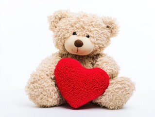 Plush teddy bear holding red heart on white background
