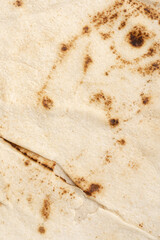 Thin lavash isolated on white background. Armenian unleavened lavash. Lavash as textured bread background.	
