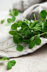 Fresh pea shoots resting on linen cloth, healthy microgreens for culinary delights