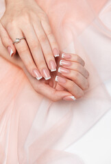 Woman showing french manicure on pink background