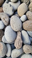 Madeira’s beaches are often covered in smooth pebbles made from igneous rocks like basalt and trachyte, shaped by erosion and wave action. These volcanic stones vary in color and texture, reflecting t