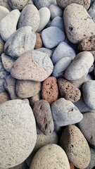 Madeira’s beaches are often covered in smooth pebbles made from igneous rocks like basalt and trachyte, shaped by erosion and wave action. These volcanic stones vary in color and texture, reflecting t