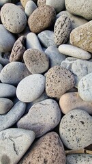 Madeira’s beaches are often covered in smooth pebbles made from igneous rocks like basalt and trachyte, shaped by erosion and wave action. These volcanic stones vary in color and texture, reflecting t