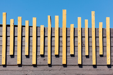 A row of wooden boards, some of which are yellow and some are brown