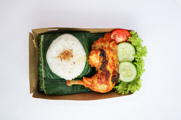 Flat lay Grilled Chicken with rice or Nasi Ayam Bakar Lalapan, Authentic recipe of Indonesian chicken. Selective focus