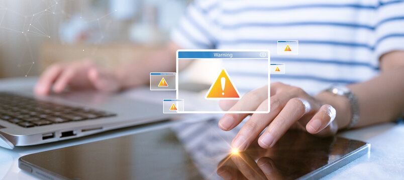 A person using a laptop and tablet encounters multiple cybersecurity warning pop-ups. The image represents online security threats, data breaches, and malware risks in the digital world.