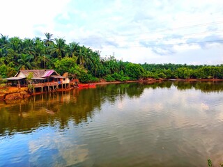 Serene Lakeside Village Tranquil Waters, Lush Greenery, and Picturesque Houses