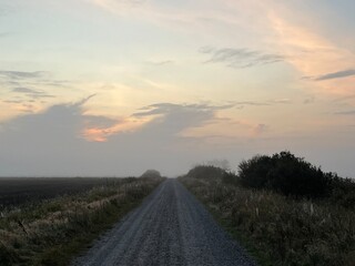 sunrise over the road a misty morning