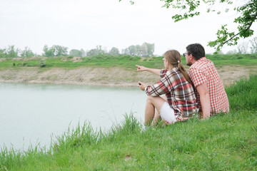 Family on picnic near the lake, looking at view