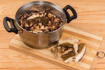 Dried boletus soaked in cold water and dry mushrooms beside
