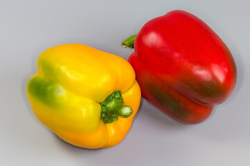 Raw yellow and red bell peppers with the greenish sides