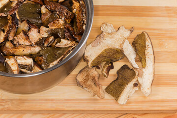 Dried boletus soaked in cold water and dry mushrooms beside