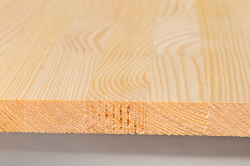 End of wooden panel made of softwood planks close-up