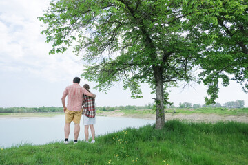 Family on picnic near the lake, looking at view
