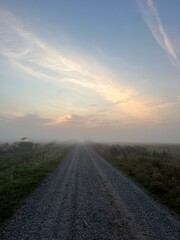 sunrise in the fog over the road a misty morning