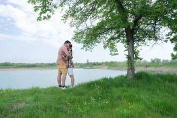 Family on picnic near the lake, looking at view