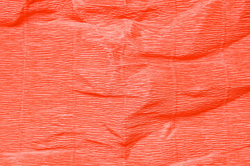Texture of crumpled corrugate coral paper as background, closeup