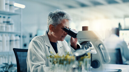 Microscope, biology and science with woman in laboratory for gene function, discovery and medical...