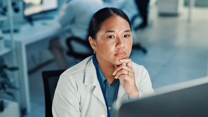 Computer, science and thinking with woman in laboratory for online development or research. Healthcare, innovation and problem solving with Asian scientist at desk for breakthrough or clinical trial