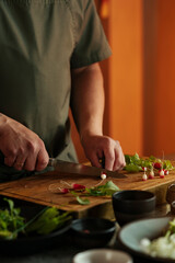 Male chef preparing salad in restaurant kitchen